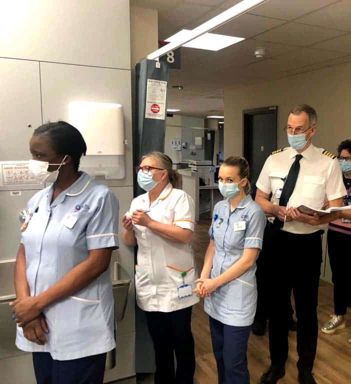 A WingFactors pilot in uniform observing NHS nurses during a live clinical simulation